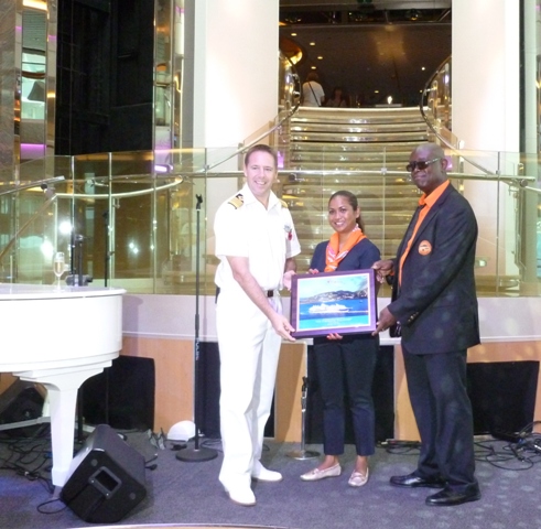 PHOTO CUTLINE: TUI Discovery Captain John Westgarth-Pratt receiving a plaque from Port St. Maarten Commercial Department representative Ichel Moeslikan as Dutch St. Maarten Taxi Association rep looks on.