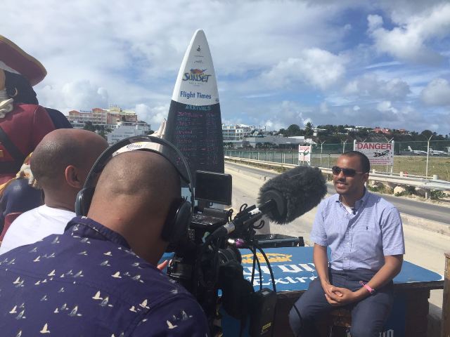 Caption: Head of the St. Maarten Tourist Bureau Rolando Brison being interviewed by the BBC Travel Show.